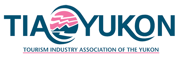 Blue and pink letters creating the Tourism Industry Association Yukon logo