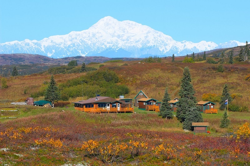 Caribou Lodge Alaska in fall colors and snowcapped mountains in the back