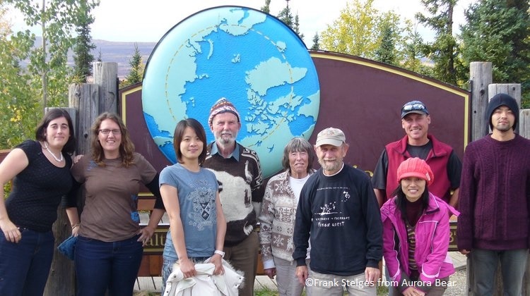 Group of people in front of the Arctic Circle sign