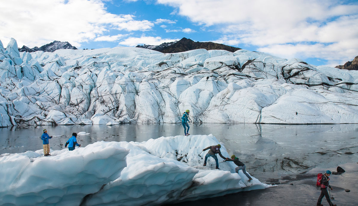 people climbing on a glacier