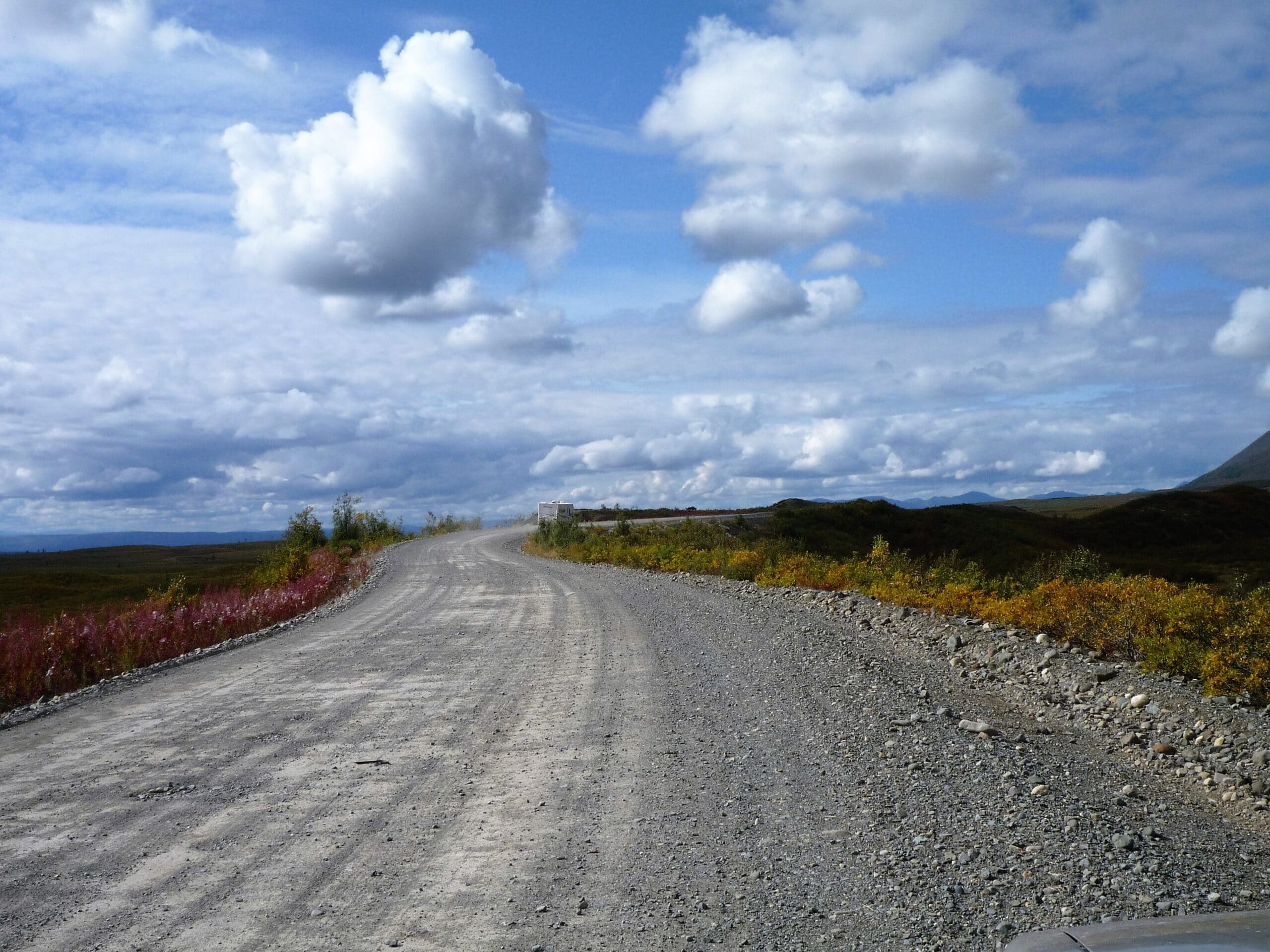 Gravel road with blue sky and some clouds