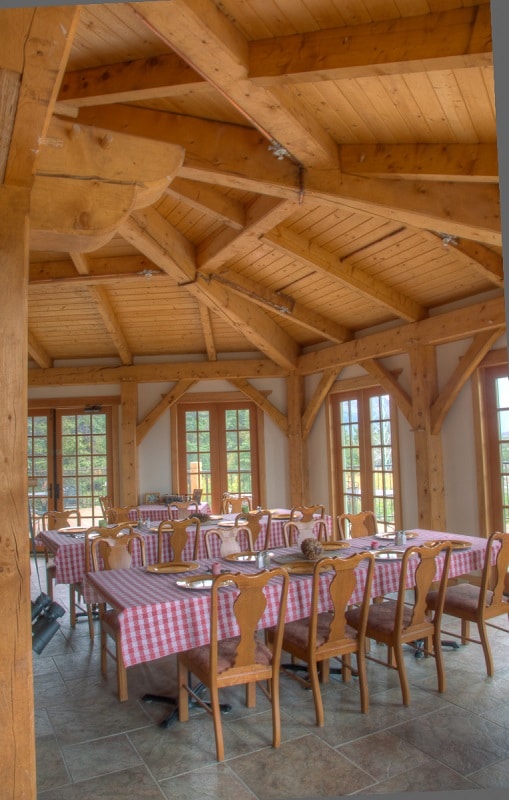 a dining room, red white checkered tablecloths honey colored wooden ceiling
