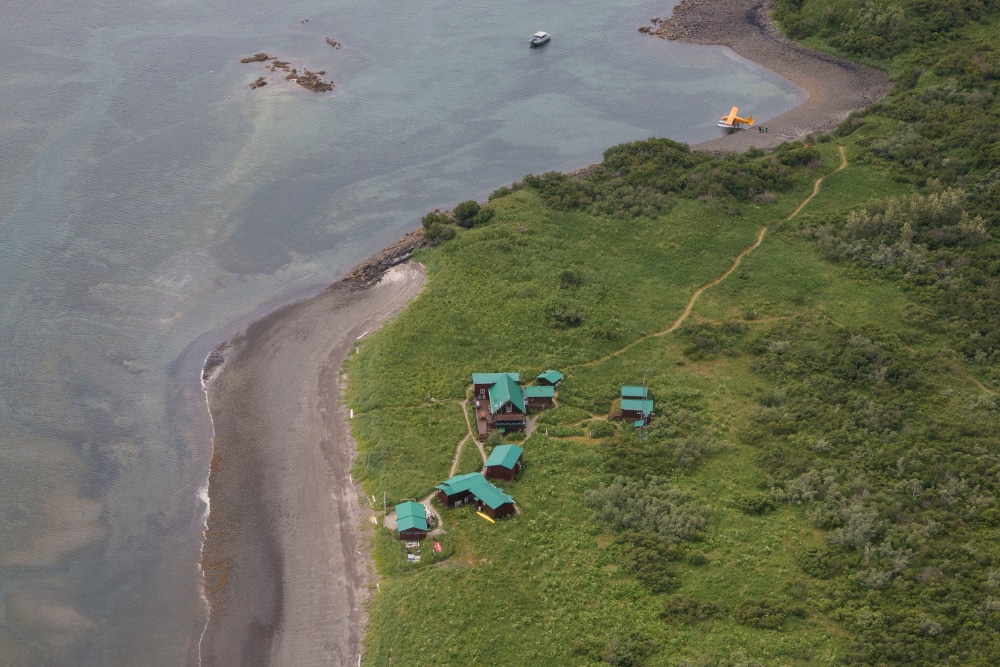 Aerial view of Katmai Wilderness Lodge at the coast green roofs
