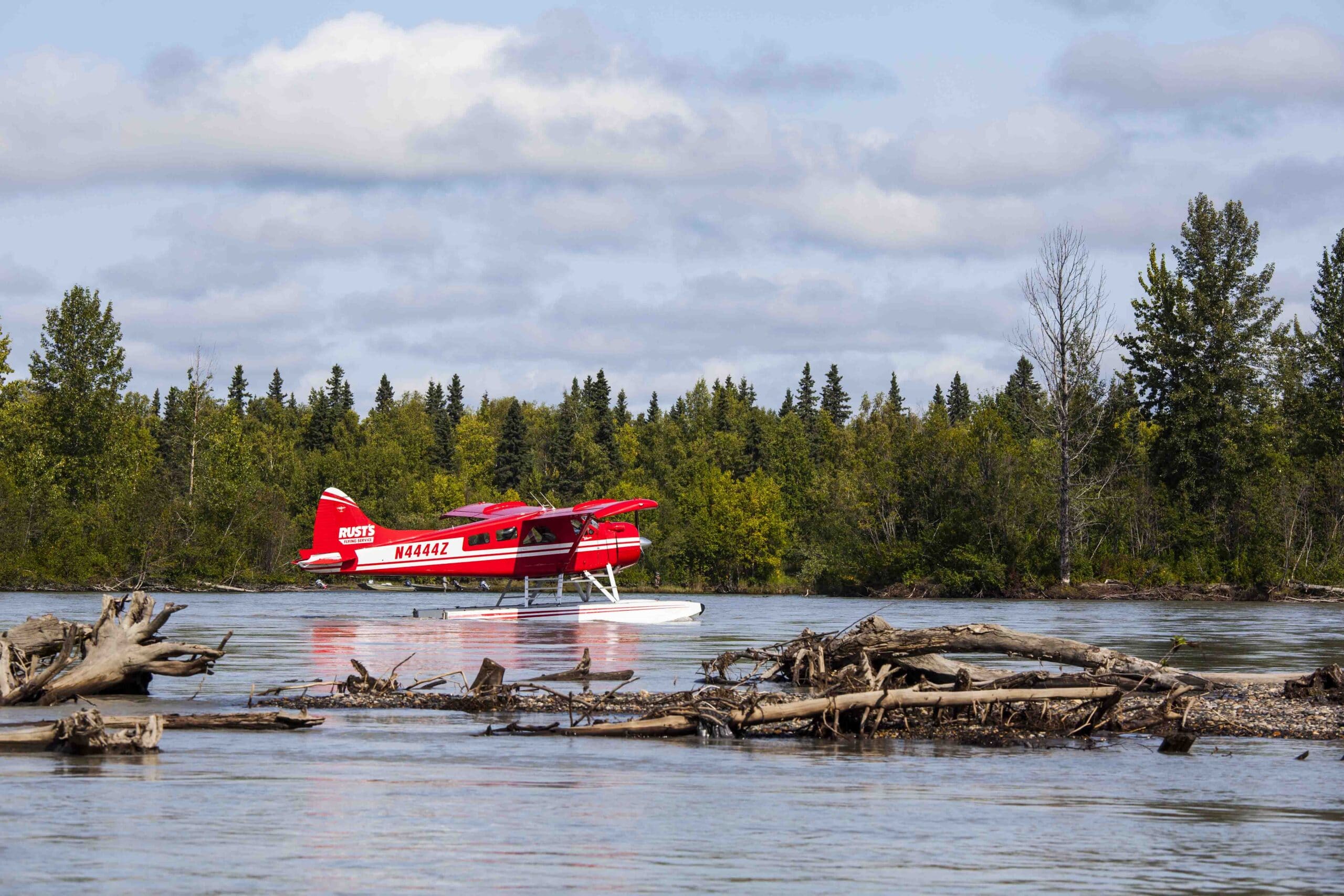 Red Seaplane in the water wood in the front trees in the back
