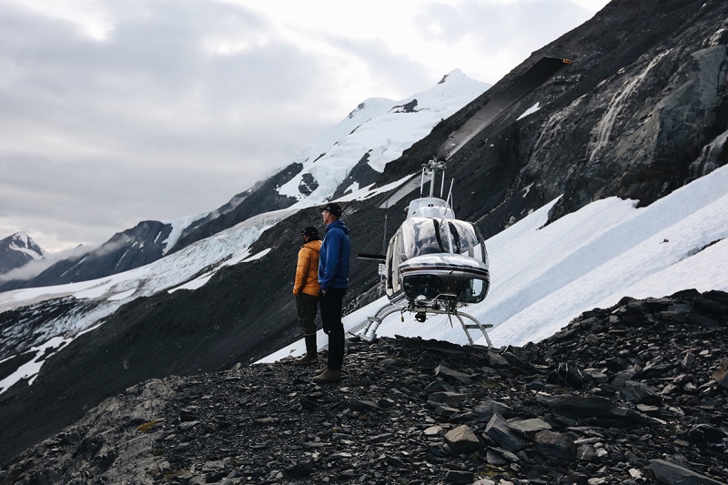 Helicopter landing near glacier , Alaska Helicopter Tours